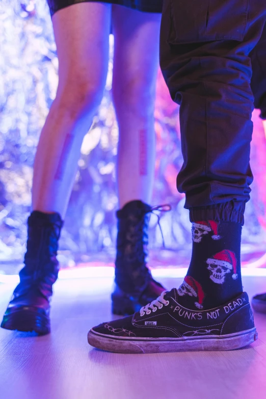 legs in black high top sneakers on stage