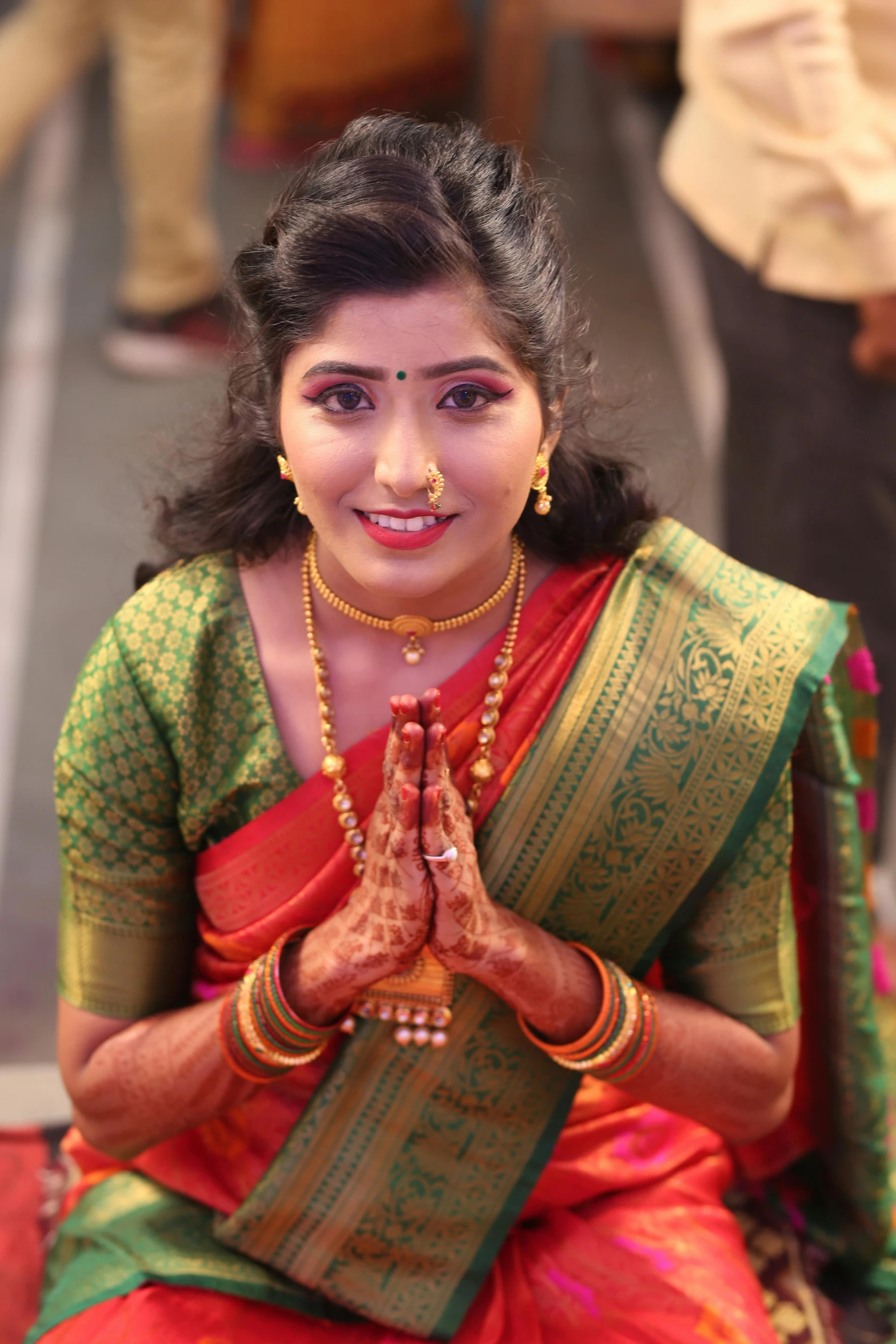 beautiful indian woman dressed in traditional clothes, smiling and clapping