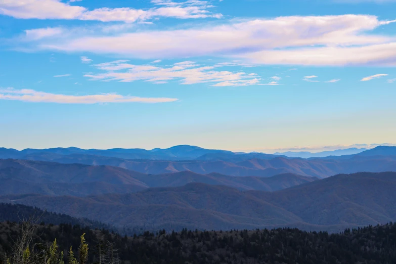 there is a view of mountains from the top of a hill