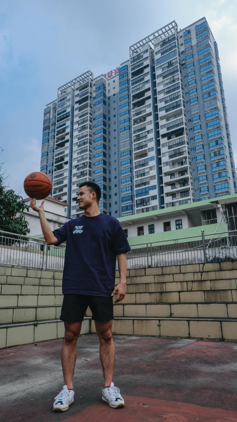 a man in blue is holding a basketball