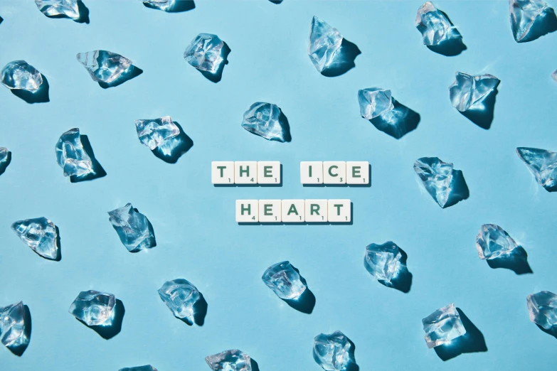 a bunch of ice pieces in front of a typewriter word made out of diced letters