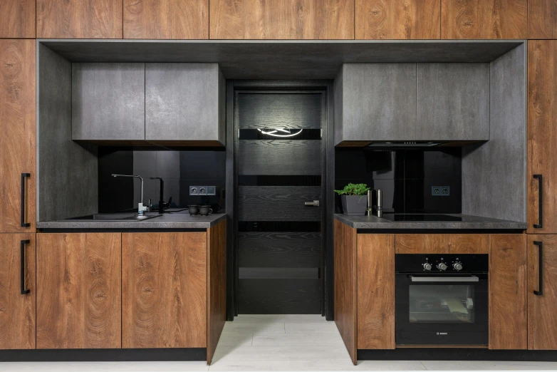 a modern kitchen with wood paneling and black appliances