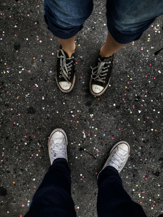 people standing on a street with their feet up