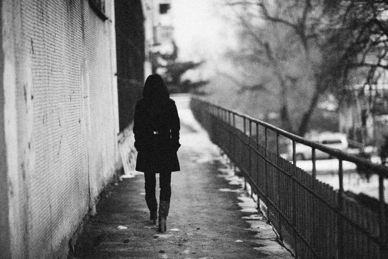 the woman walks in the street alone and alone