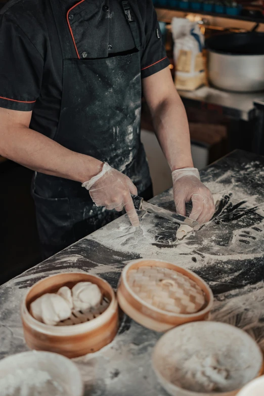 a man making food with various ingredients and knills