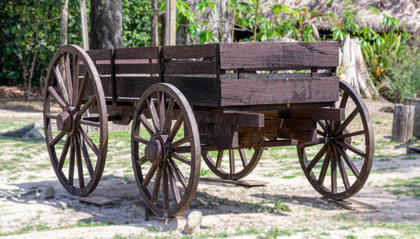 an old wooden wagon with wheels is out