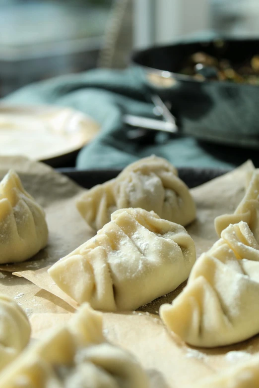 some dumplings on a table that are ready to be made into dumpling dishes