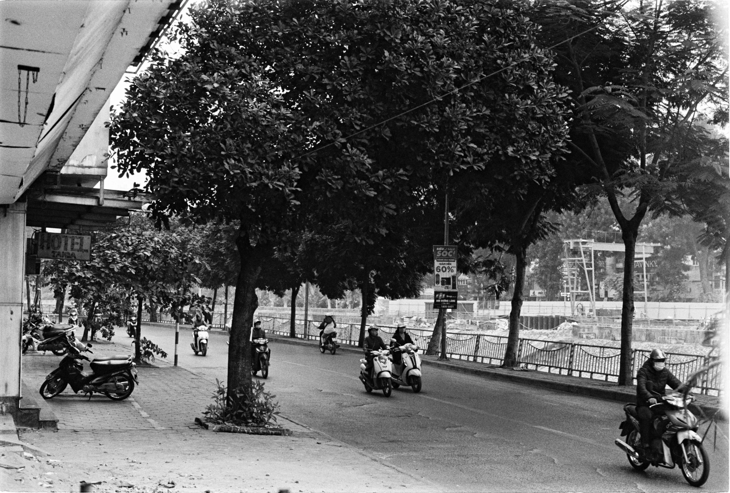 old picture of a group of people riding scooters