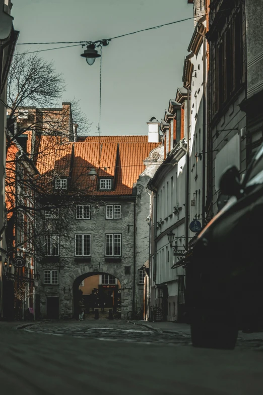 an old fashioned european style city street is shown