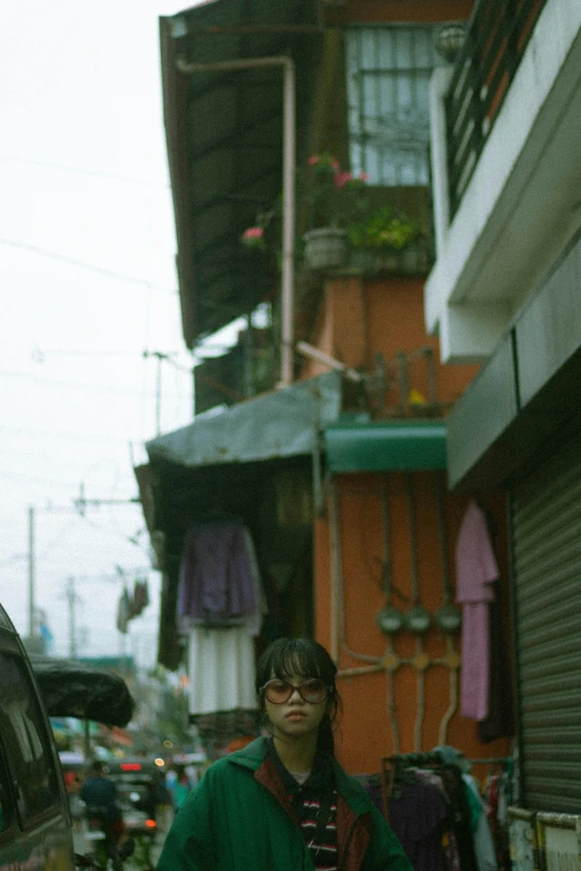 a woman standing in front of a tall building