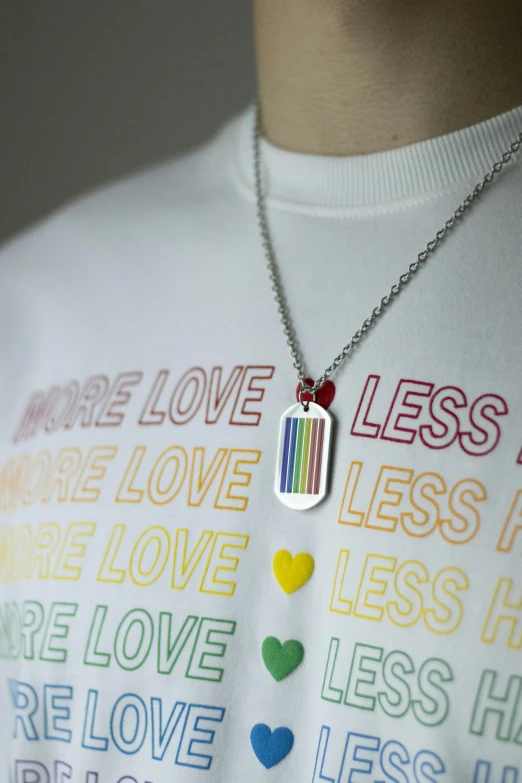 a white shirt with a love, less love necklace hanging from it
