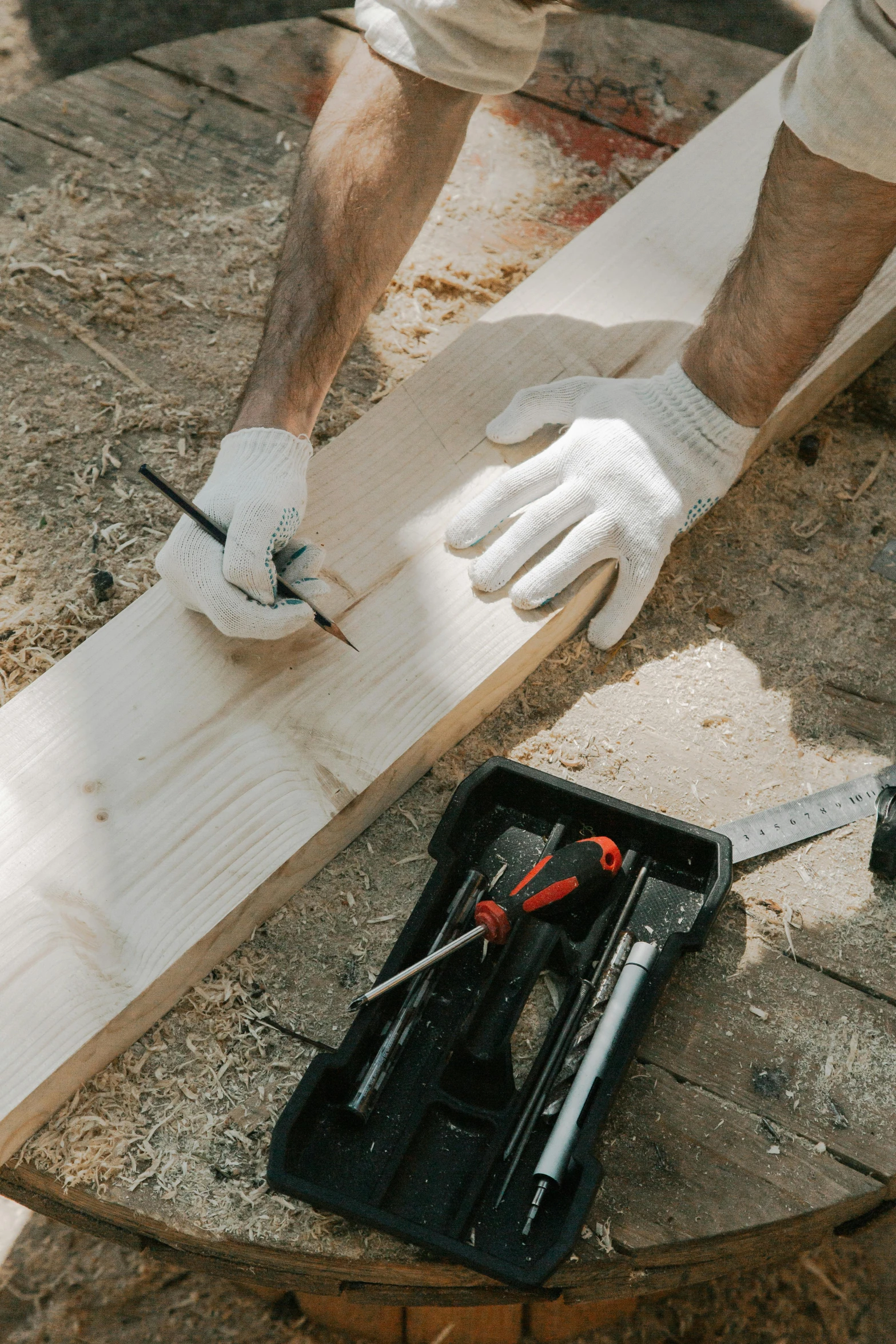 two men working on a large wooden object