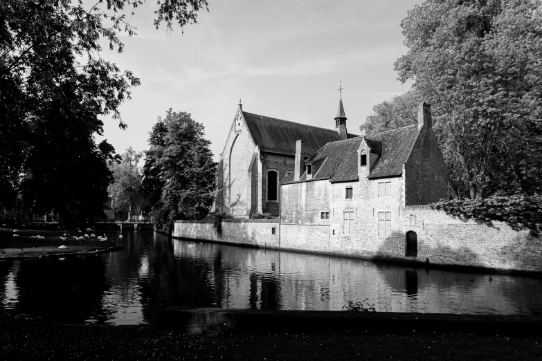 an old church building and a body of water