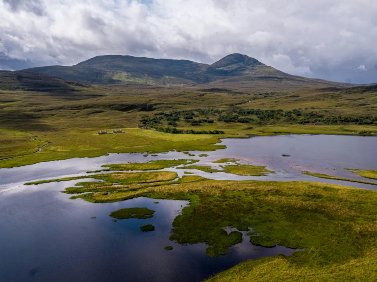 an aerial view of a large lake in the middle of two mountains