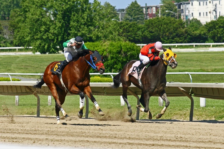 three men racing their horses down the race track