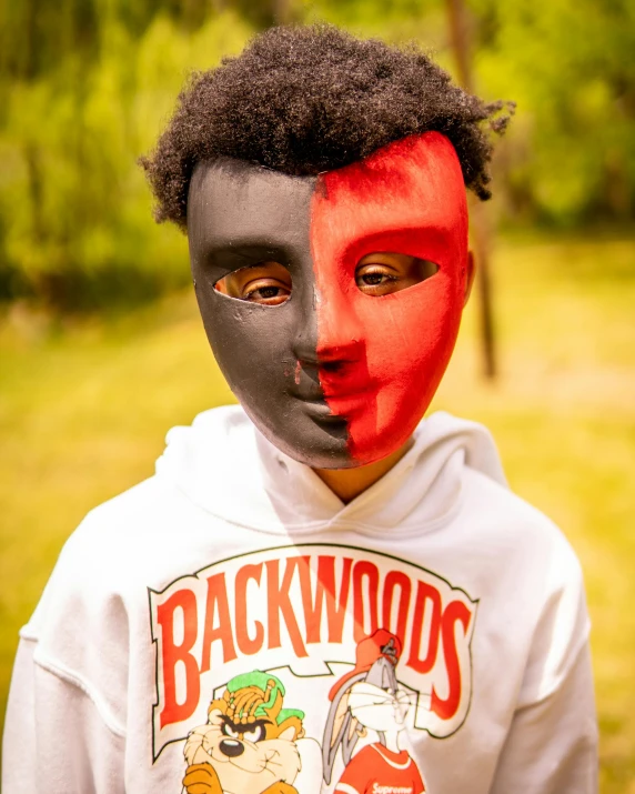 a man wearing an odd hoodie and painted face