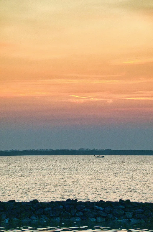 a boat is on the water at sunset