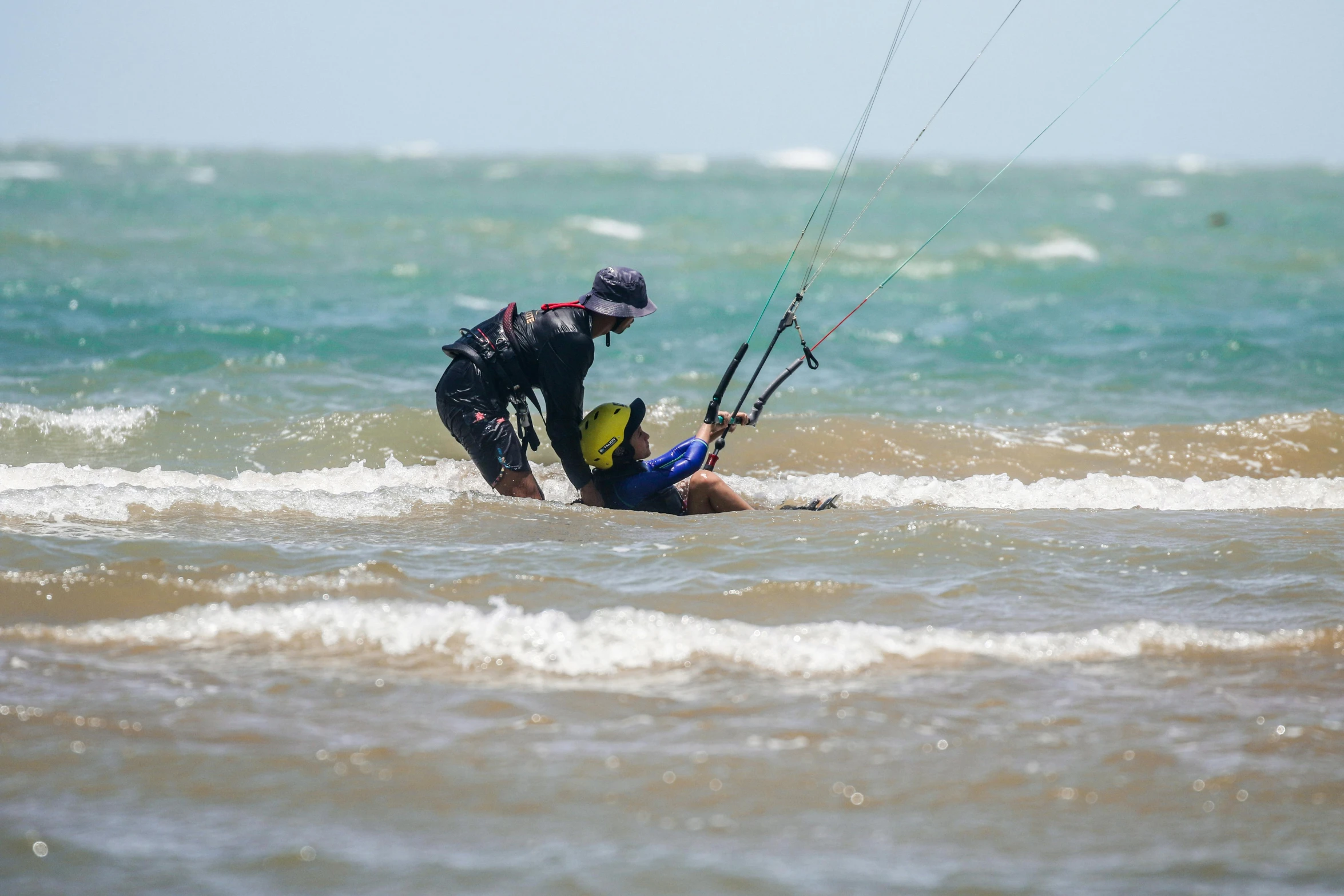 a man holding onto the side of a parasail