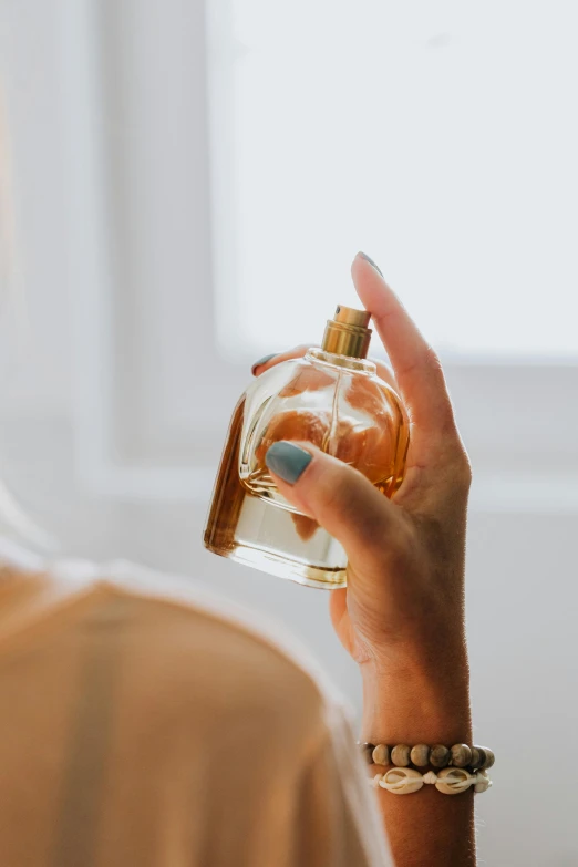 a woman holding a bottle of body soap