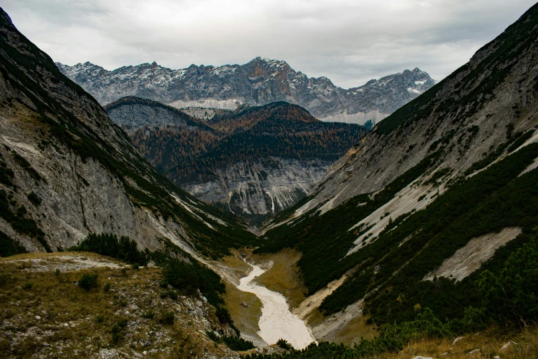 a mountain valley that is surrounded by tall mountains