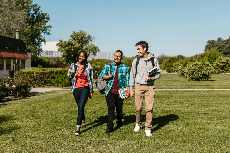 a group of young people walking across a field