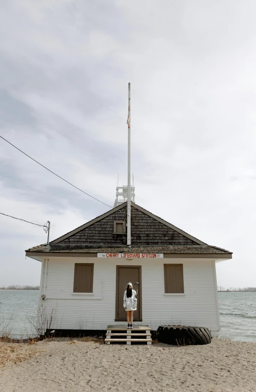 the small white building sits beside the water