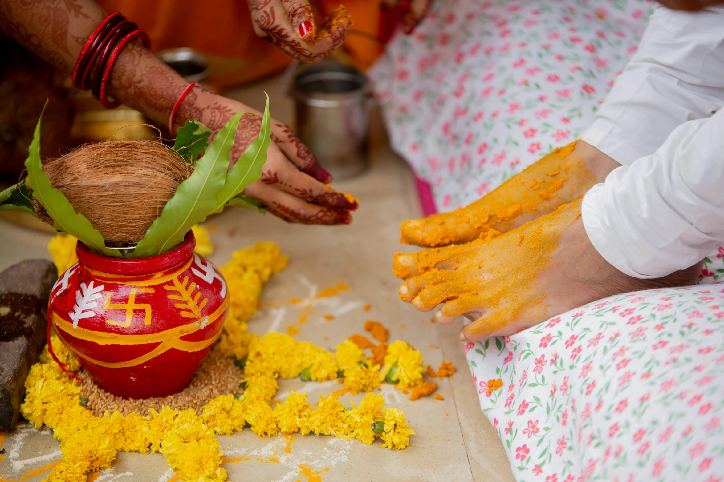 a person is giving yellow powder to someone's hand