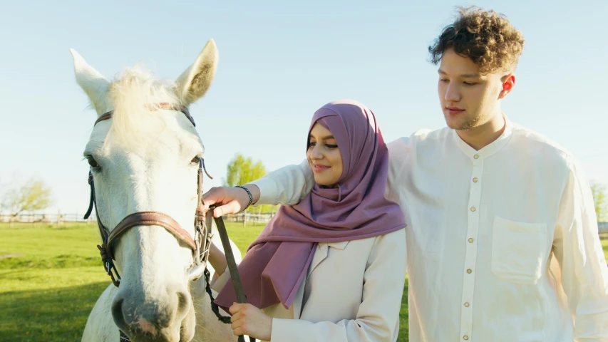 the young man and woman have stopped for their horse ride