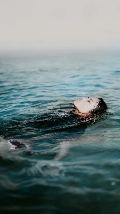a person laying down in a body of water