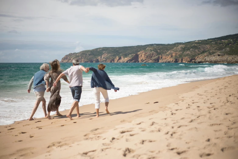 there are people standing at the edge of a beach