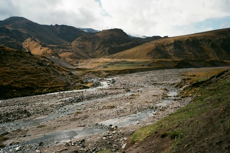 view of mountains and stream in the foreground