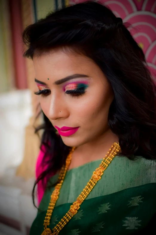 a woman with pink and green eyeshadow