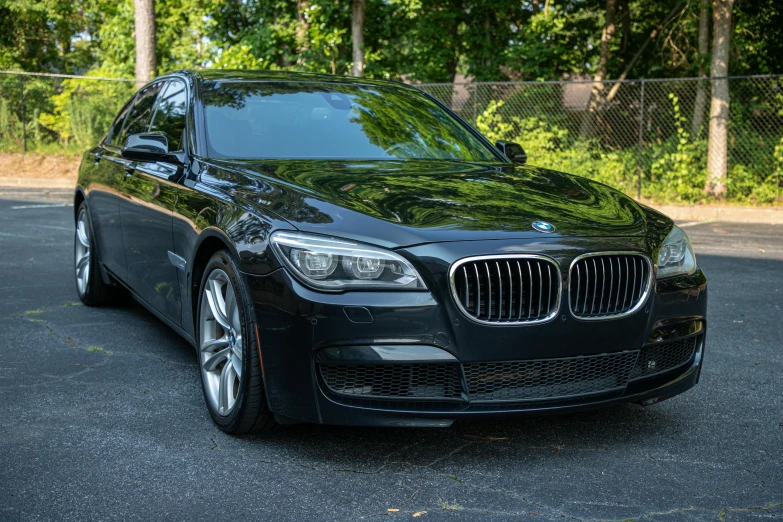 black car parked in parking lot near fence