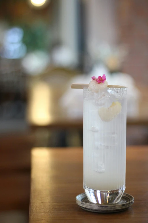 this is a glass filled with alcohol on a wooden table