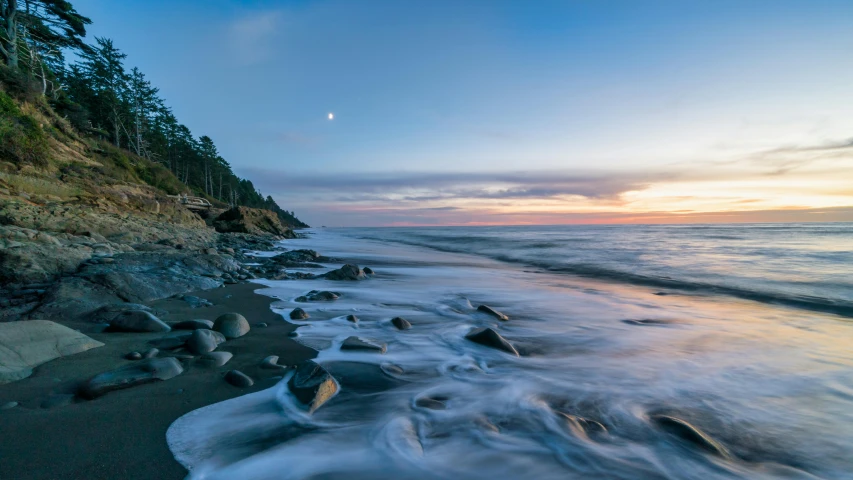 water crashing into a beach next to shore