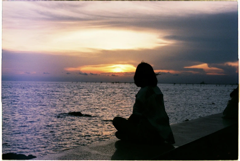 a person looking out at a body of water