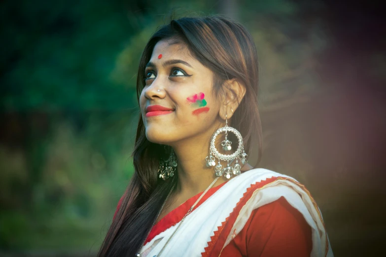 a girl smiling with colorful face makeup