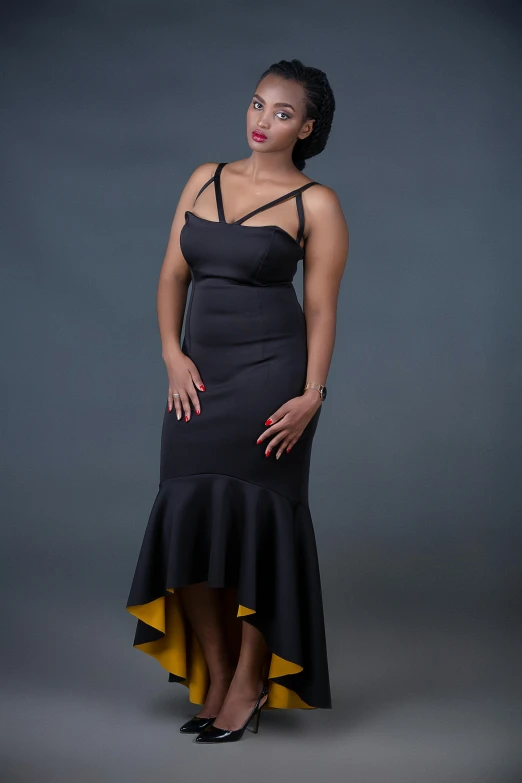 a woman in a long black dress posing for a picture