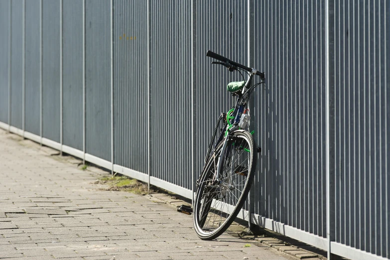 a bike leaning against a wall on the street