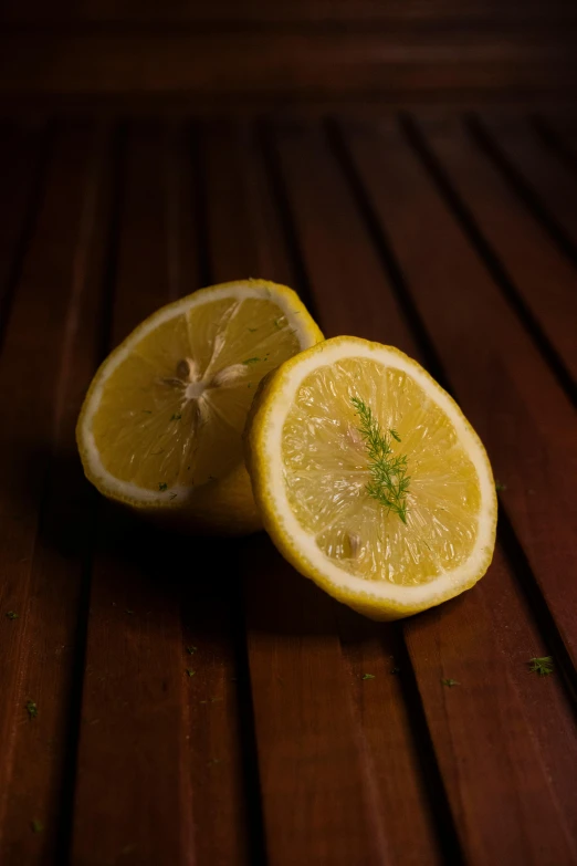 a sliced lemon is shown on the wooden floor