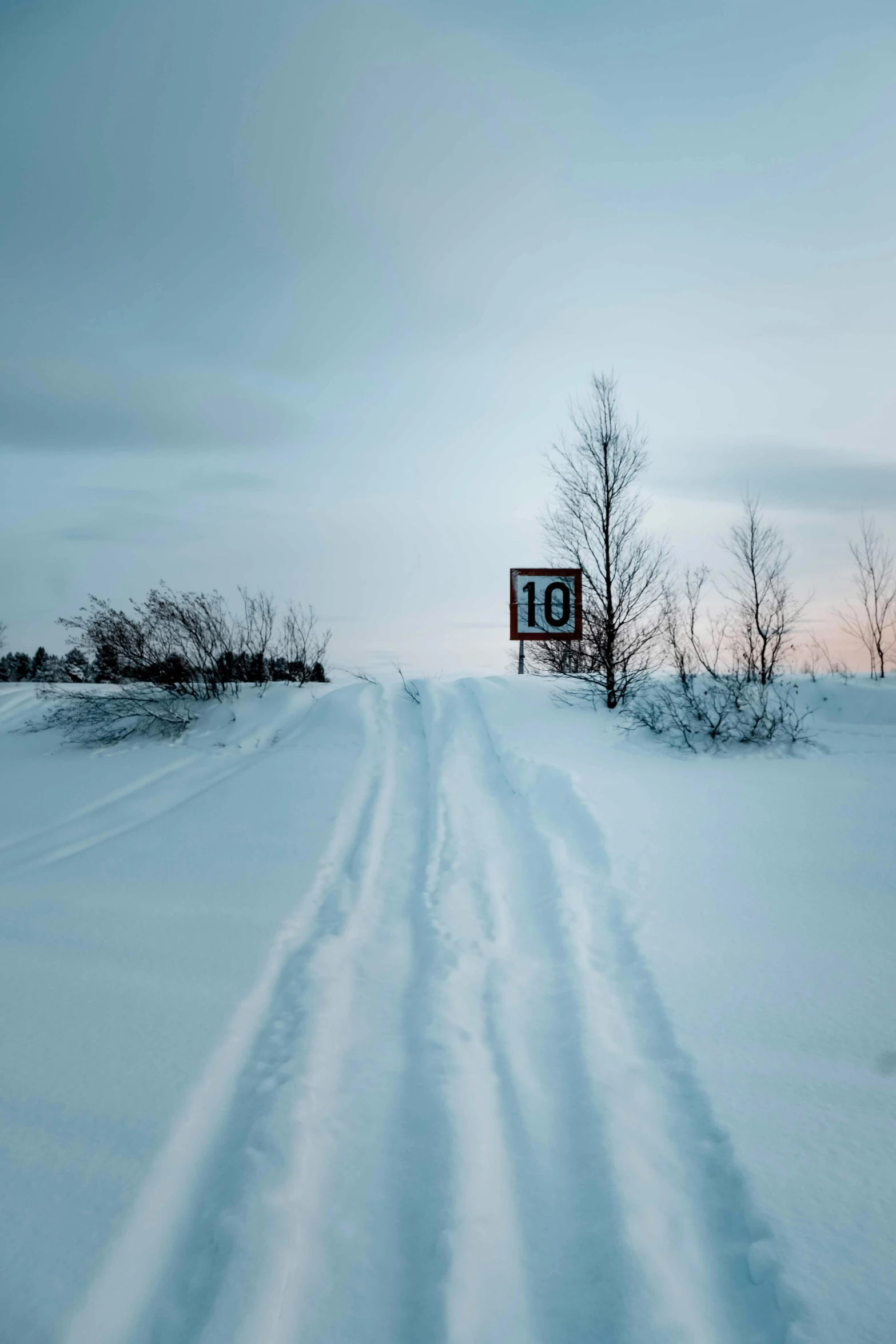 a snowy path with the number 101 in the distance