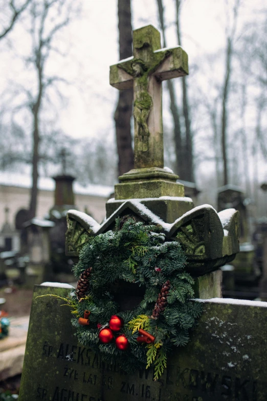 the wreath is on top of the headstone of an old cemetery