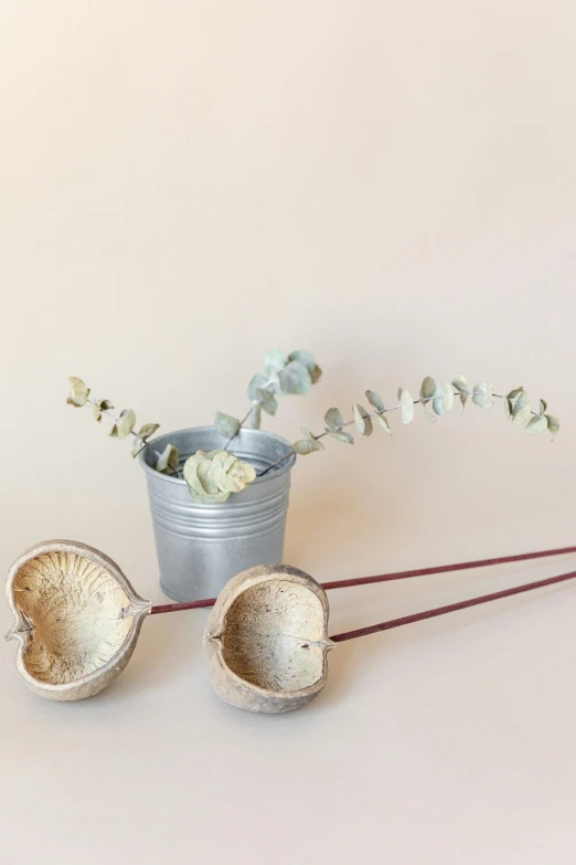 there is a flower and two leaves on the table