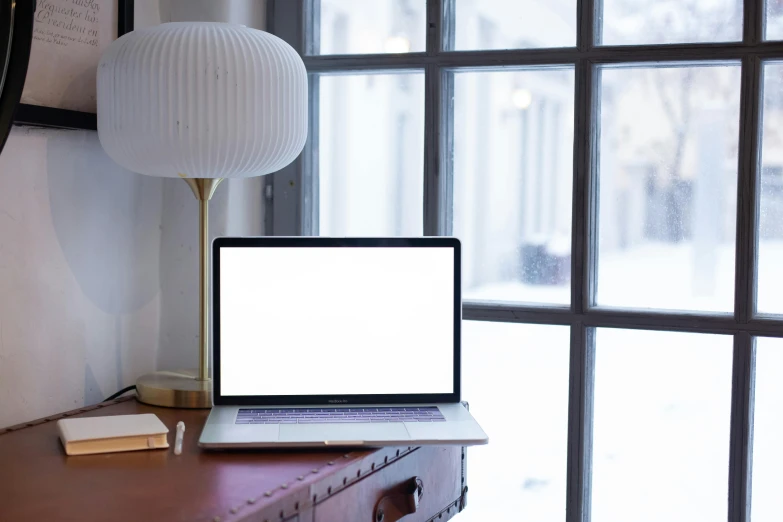 a laptop computer sitting on top of a wooden desk