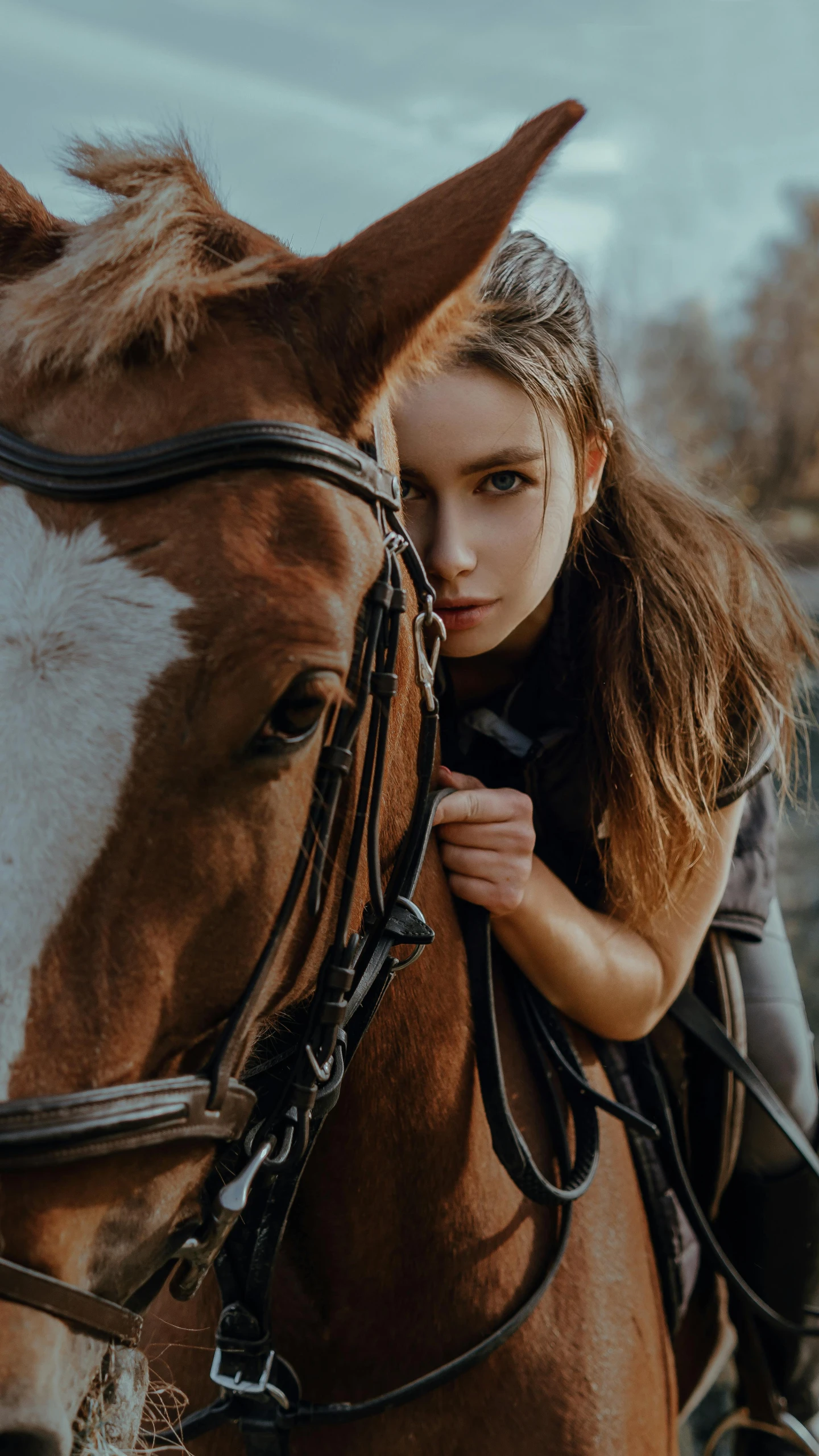 a woman holding the reigns on a horse