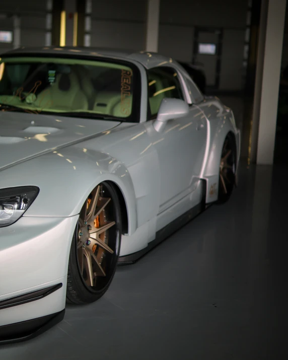 an image of a white car with golden rims