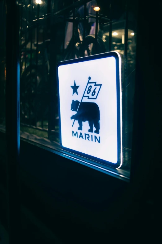 a illuminated sign for a restaurant with a bull and star