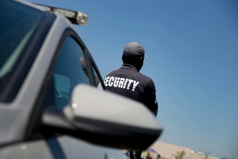 a person wearing a black jacket standing near a vehicle