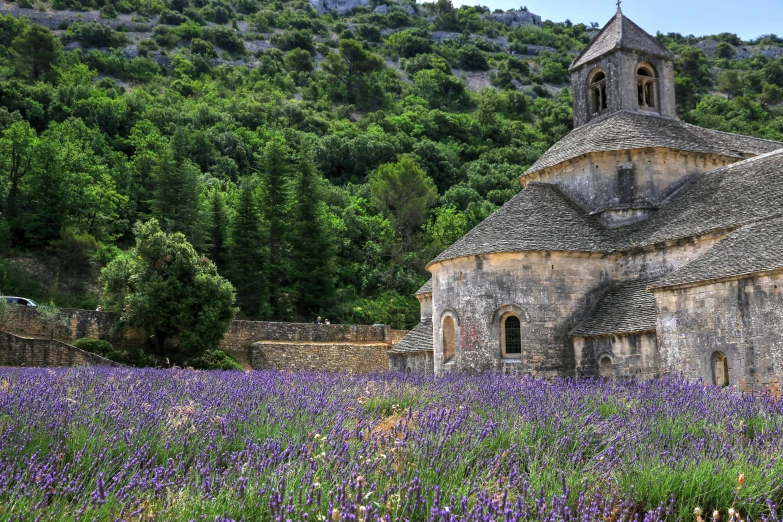 an old building in front of some mountains