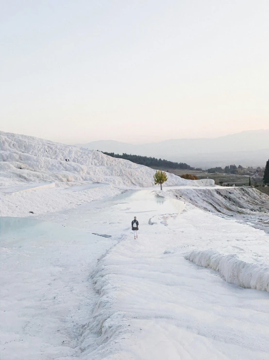 two men are walking down a snowy hill